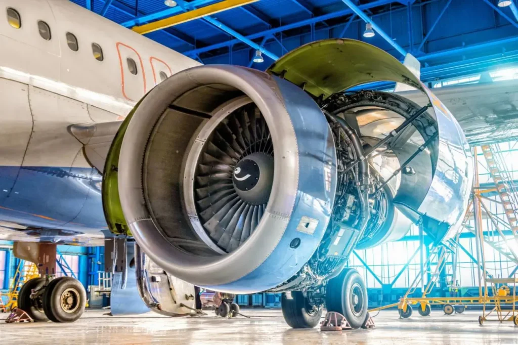 Aircraft jet engine inspection inside aerospace maintenance facility